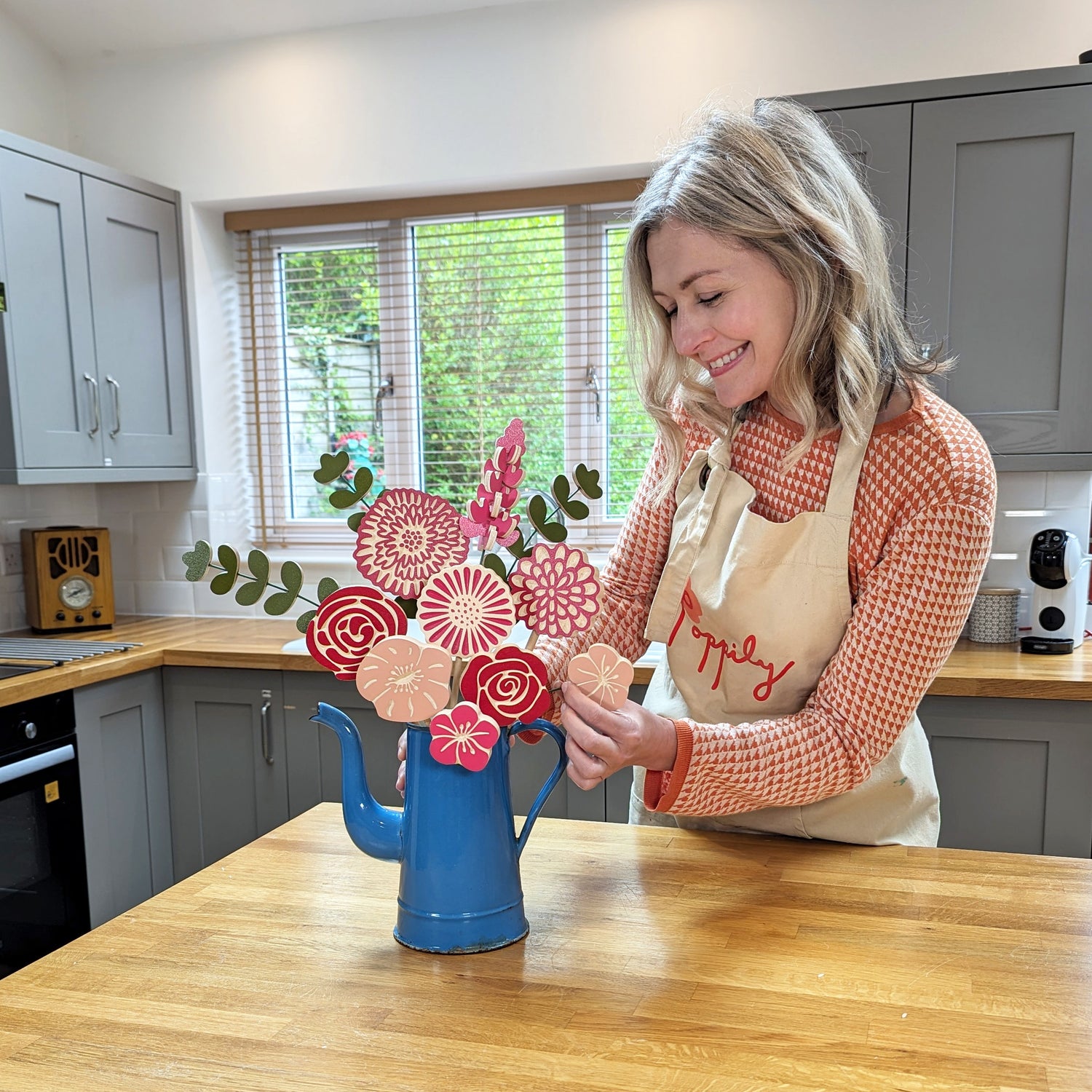 Poppily Natalie Arranging Rosy Posy Wooden Flowers In Kitchen