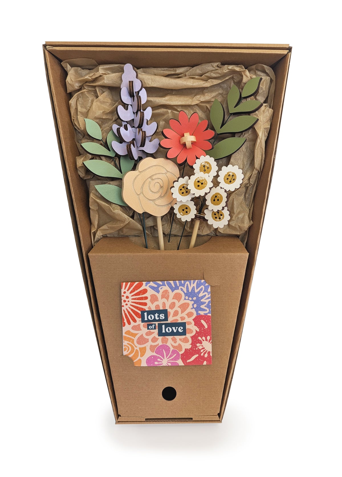 Signature Blooms in Sorbet, four wooden blooms and two foliage stems in muted mustard, lilac, peach, coral and sage, in its open box with the stems held in place