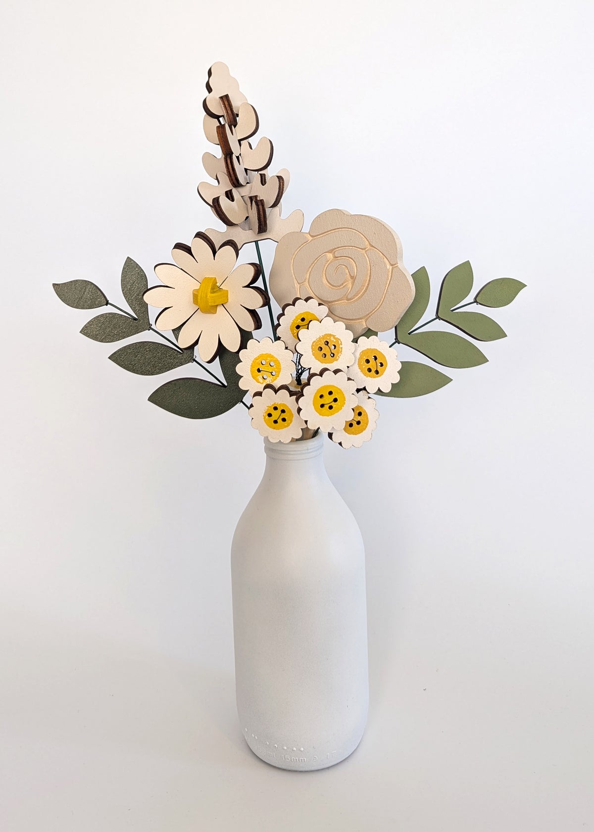 Signature Blooms in Sunny Side, four wooden blooms and two foliage stems in grey and white with a touch of sunshine yellow, in a vase