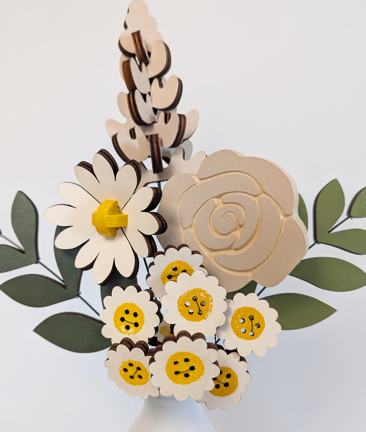 Signature Blooms in Sunny Side, a close crop of the wooden blooms in grey and white with a touch of sunshine yellow