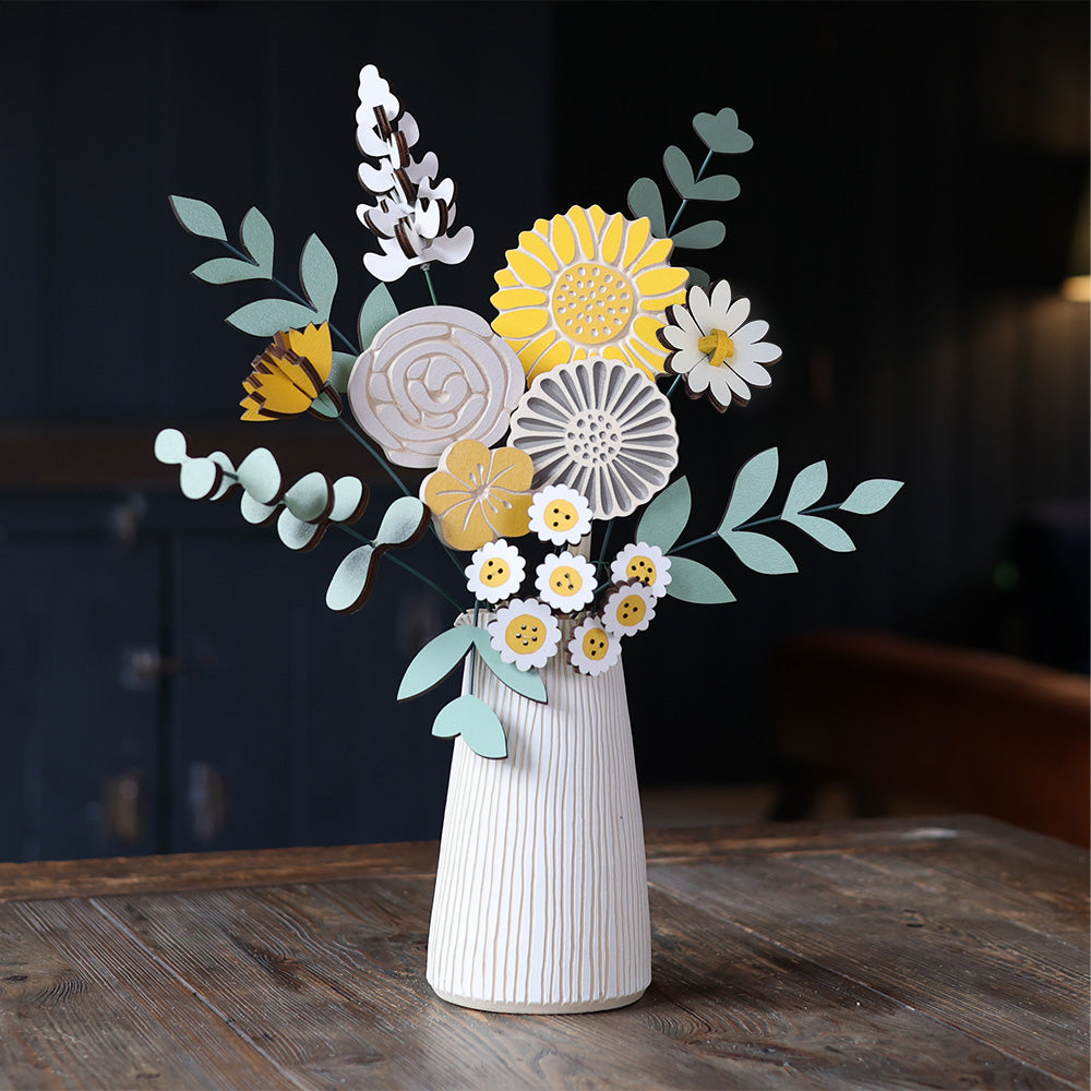 Statement Blooms in Sunny Side, eight wooden blooms and five foliage sprigs in grey and white with a touch of sunshine yellow, styled in a room 