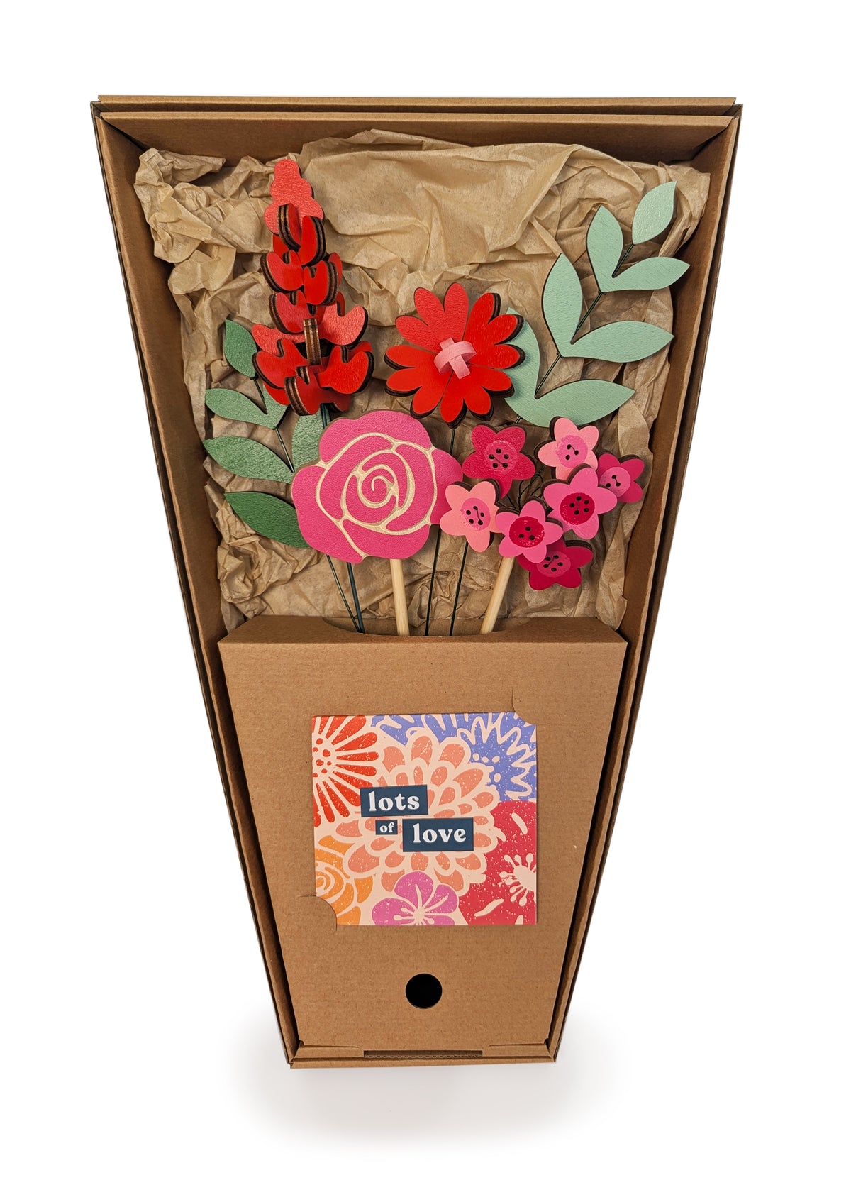 Signature Blooms in Framboise, four wooden blooms and two foliage stems in red, fuchsia and pink, in its open box with the stems held in place 