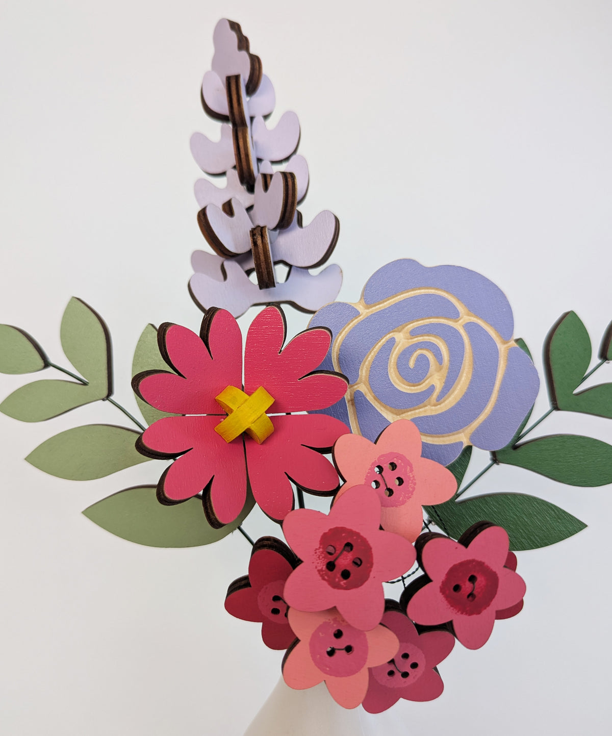 Signature Blooms in Macaron, a close crop of the wooden blooms in bright pink and violet 