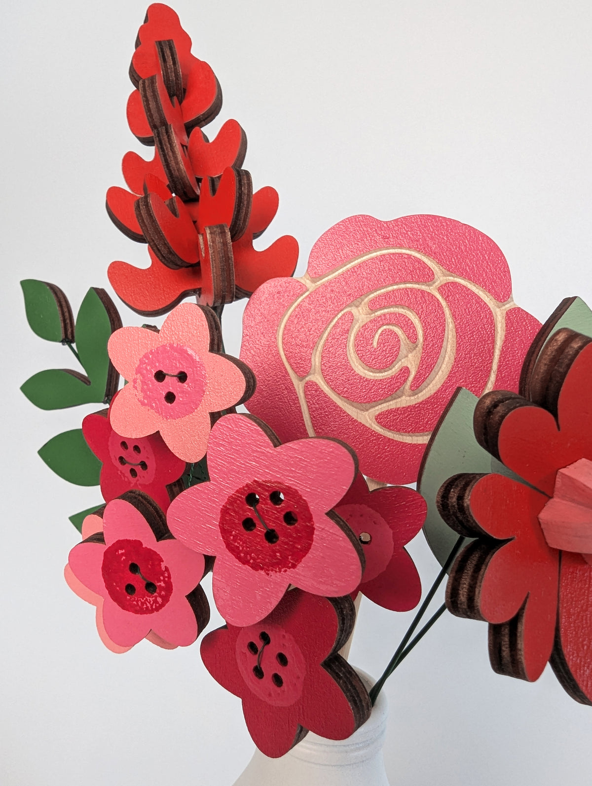 Signature Blooms in Framboise, a macro detail of the painted facets in red, fuchsia and pink 